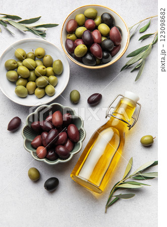 Assorted olives with olive oil and olive branches creating culinary delight Assorted olives with olive oil and olive branches creating culinary delight 123098682