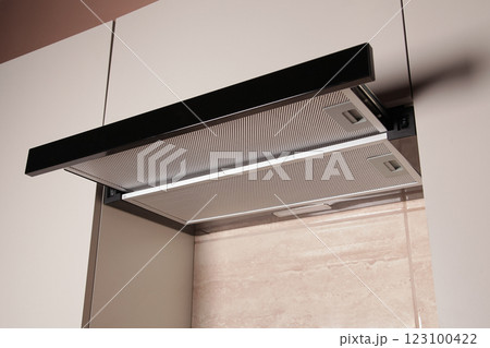 Modern Range Hood. Cooking Hood. Kitchen with Modern interior light beige color, Household Appliances. Cooking food at Home 123100422