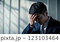 額に手を当てて悩むスーツを着たサラリーマン 123103464