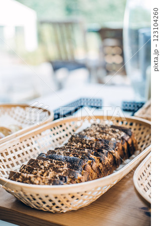 Close-up of homemade artisan bread slices arranged in wicker baskets, highlighting fresh baking, cozy kitchen vibes, and rustic food styling 123104260