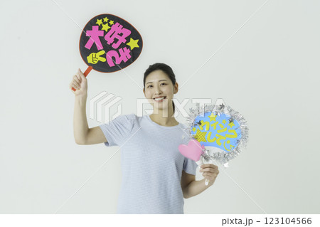 推し活　白背景のうちわを持って推しを応援する若い女性 123104566