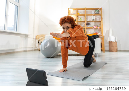 Fitness Workout training. Young healthy fit African girl doing sports exercise on yoga mat on floor at home. Athletic woman in sportswear have training workout for weight loss. Sport and fitness Fitness Workout training. Young healthy fit African girl doing sports exercise on yoga mat on floor at home. Athletic woman in sportswear have training workout for weight loss. Sport and fitness 123104789