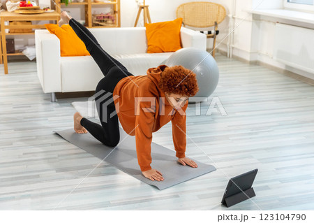 Fitness Workout training. Young healthy fit african girl doing sports exercise on yoga mat on floor at home. Athletic woman in sportswear have training workout for weight loss. Sport and fitness 123104790