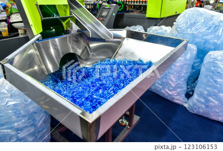 Blue Plastic bottles in production line at manufacturing PET bottle perform, before bottles blowing in blowing machine at drink water factory. 123106153
