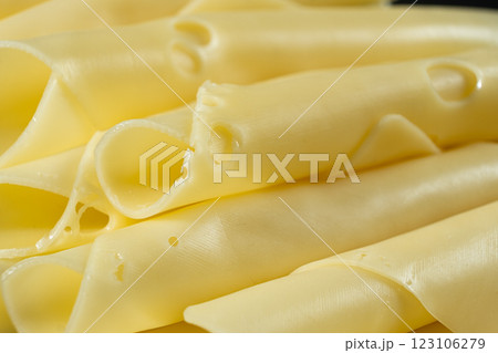 Semi-hard cheese, thin slices, rolled into tubes. Semi-hard cheese, thin slices, rolled into tubes. 123106279