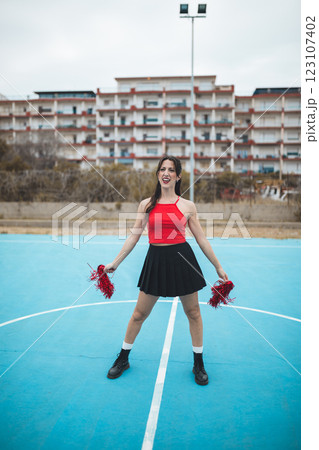 Cheerleader Girl Cheers Her Team On The Basketball Court 123107402