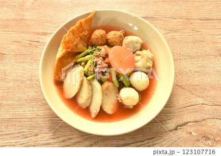 boiled Chinese Hakka meatball made from chop pork stuffing fried tofu with morning glory in spicy red sauce tom yum soup on plate 123107716