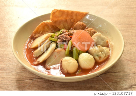 boiled Chinese Hakka meatball made from chop pork stuffing fried tofu with morning glory in spicy red sauce tom yum soup on plate 123107717