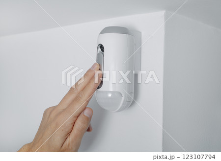 man connecting the camera of a burglar alarm 123107794