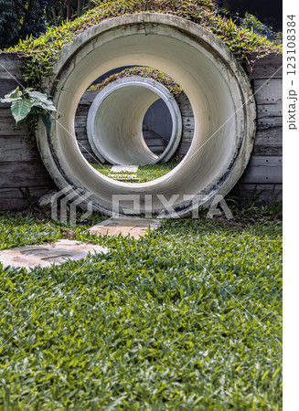 Outdoor playground with The kid's playing tunnel with Grass mound on top in the park for children. Outdoor playground with The kid's playing tunnel with Grass mound on top in the park for children. 123108384