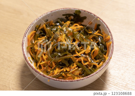 Close up shot of the salad made of carrots and seaweed in the clay bawl. Food Close up shot of the salad made of carrots and seaweed in the clay bawl. Food 123108688