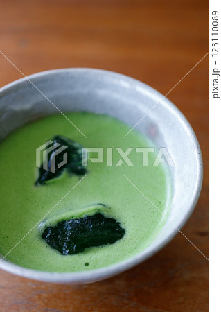 Cup of fresh matcha tea, green tea on wooden table Cup of fresh matcha tea, green tea on wooden table 123110089