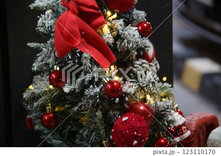 red christmas tree with decorated decoration 123110170