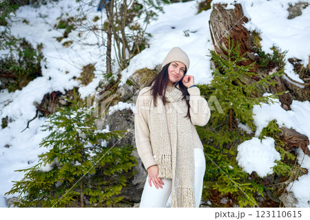 Serene Winter Portrait of a Woman in a Snowy Mountain Landscape, Wearing a Cream Chunky-Knit Sweater and Beige Knitted Scarf, with a Contemplative Expression, Surrounded by Fresh Snow and Evergreen Serene Winter Portrait of a Woman in a Snowy Mountain Landscape, Wearing a Cream Chunky-Knit Sweater and Beige Knitted Scarf, with a Contemplative Expression, Surrounded by Fresh Snow and Evergreen 123110615