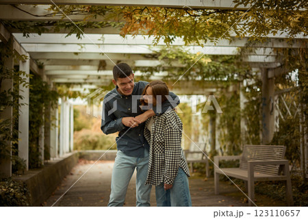 Young Cute Female Hugs Boyfriend. In Autumn Outdoor. Lovers Walking in Park. Attractive Funny Couple. Lovestory in Forest. Man and Woman. Cute Lovers in the Park. Family Concept. Happy Couple. Young Cute Female Hugs Boyfriend. In Autumn Outdoor. Lovers Walking in Park. Attractive Funny Couple. Lovestory in Forest. Man and Woman. Cute Lovers in the Park. Family Concept. Happy Couple. 123110657