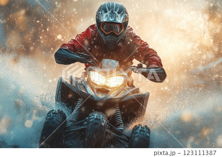 Rider navigating rough terrain on an all-terrain vehicle during a rainy day, creating splashes and a thrilling experience 123111387