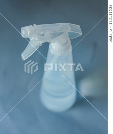 Clear plastic spray bottle filled with water,isolated against neutral background. High quality photo 123111538