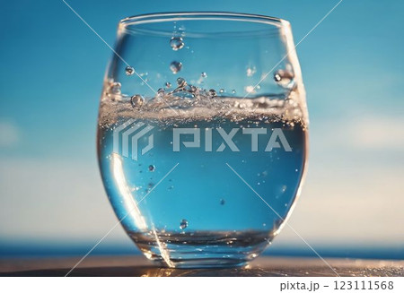 glass of water on the beach 123111568