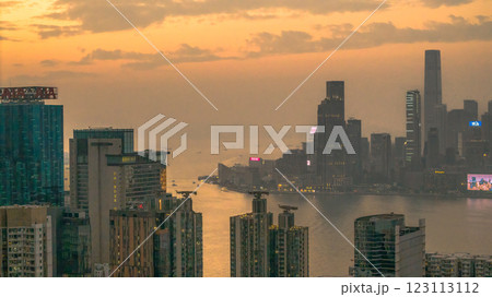 Jan 5 2025 Cityscape at Sunset with Urban Buildings and Distant Harbor, Hong Kong Jan 5 2025 Cityscape at Sunset with Urban Buildings and Distant Harbor, Hong Kong 123113112