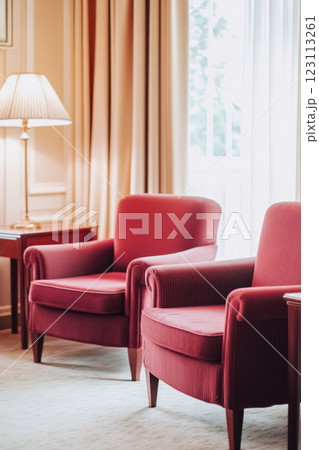 Cozy retro living room showcases cherry-colored sofas and armchairs with warm, inviting lighting 123113261