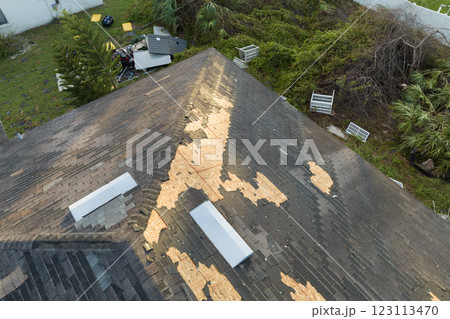 Natural disaster and its consequences. Hurricane Ian destroyed house roof in Florida residential area 123113470