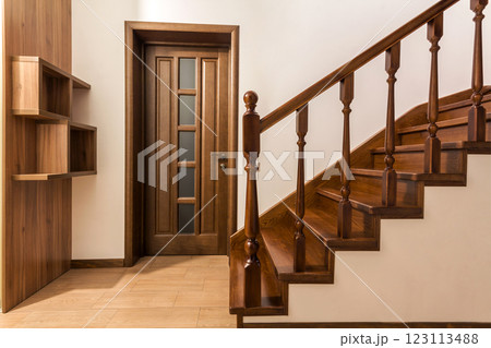 Modern brown oak wooden stairs and doors in new renovated house interior 123113488