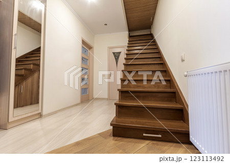 Modern architecture interior with elegant luxury hallway with glossy wooden staps stairs in modern storey house 123113492