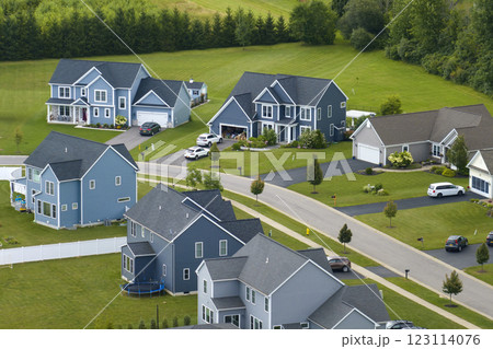 Low-density two story private homes with large lot size and green grassy lawns in summer season. Rural residential suburbs with upscale suburban houses outside of Rochester, New York 123114076