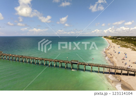 Idyllic summer day over sandy beach at Venice fishing pier in Florida. Summer seascape with surf waves crashing on sea shore Idyllic summer day over sandy beach at Venice fishing pier in Florida. Summer seascape with surf waves crashing on sea shore 123114104