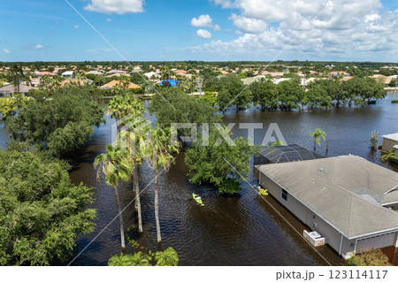 Hurricane Debby flooded street in Sarasota, Florida. Victims kayaking on rainfall flood waters between rural homes in residential area 123114117