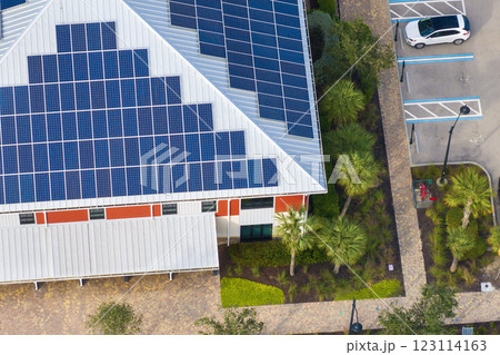 Florida office building with solar roof. Blue photovoltaic panels for producing clean ecological electric energy. Investing in renewable electricity concept Florida office building with solar roof. Blue photovoltaic panels for producing clean ecological electric energy. Investing in renewable electricity concept 123114163