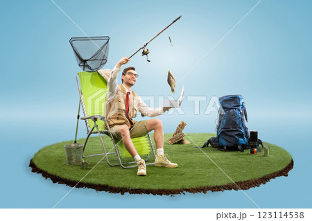 Composite image of entrepreneur in vest and tie proudly lifting fish while holding laptop on surreal floating island with camping setup. Composite image of entrepreneur in vest and tie proudly lifting fish while holding laptop on surreal floating island with camping setup. 123114538