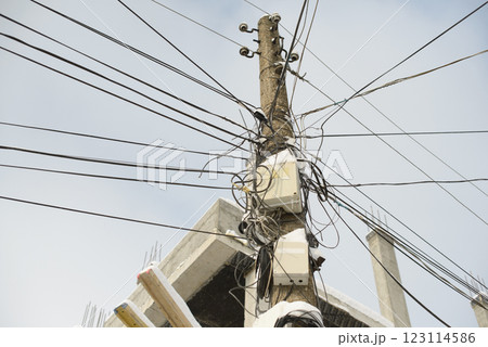Utility Pole with Messy Electrical Wiring and Cable Network 123114586