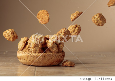 Oatmeal cookies in motion on a beige background. Oatmeal cookies in motion on a beige background. 123114663