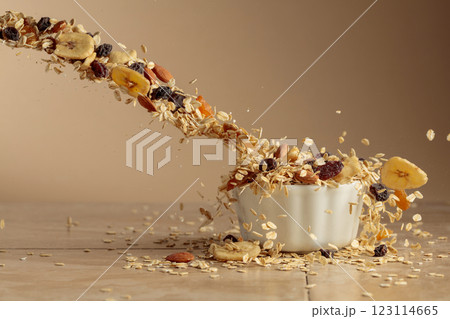 Muesli in motion on a beige background. 123114665