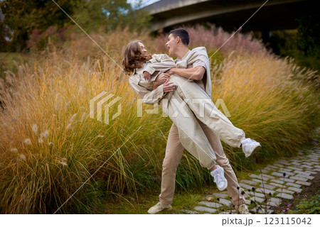 Young Cute Female Hugs Boyfriend. In Autumn Outdoor. Lovers Walking in Park. Attractive Funny Couple. Lovestory in Forest. Man and Woman. Cute Lovers in the Park. Family Concept. Happy Couple. Young Cute Female Hugs Boyfriend. In Autumn Outdoor. Lovers Walking in Park. Attractive Funny Couple. Lovestory in Forest. Man and Woman. Cute Lovers in the Park. Family Concept. Happy Couple. 123115042