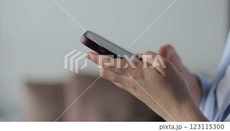 Hand of woman using texting mobile phone or chat. Close up of woman hand. 123115300