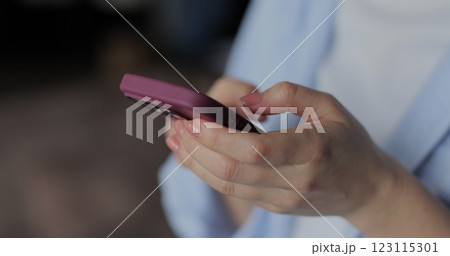 Hand of girl using smartphone in the living room at home, typing message. Close-up of young women hand. Hand of girl using smartphone in the living room at home, typing message. Close-up of young women hand. 123115301