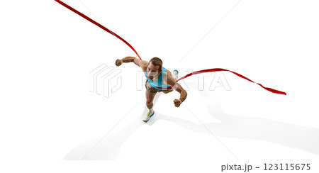 Sprinter breaking red ribbon, clenched fists and with determined face capturing final moment of race against white studio background. Sprinter breaking red ribbon, clenched fists and with determined face capturing final moment of race against white studio background. 123115675