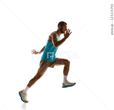 Male athlete sprinting mid-air, powerful stride and focused motion against white studio background. Concept of sport and movement. 123115701