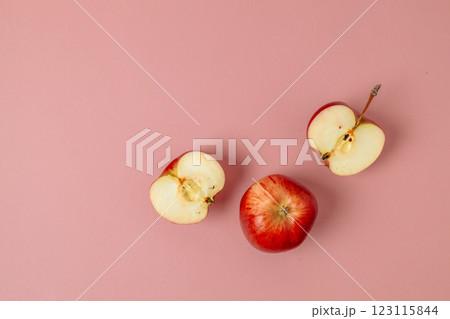 Red apple, half apple and quarter apple on pink background. Top view, healthy food concept. Top view. Red apple, half apple and quarter apple on pink background. Top view, healthy food concept. Top view. 123115844