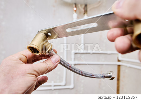 Stainless steel braided flexible hose with loose nut female ends with rubber washers on either ends connect to pipework. 123115857