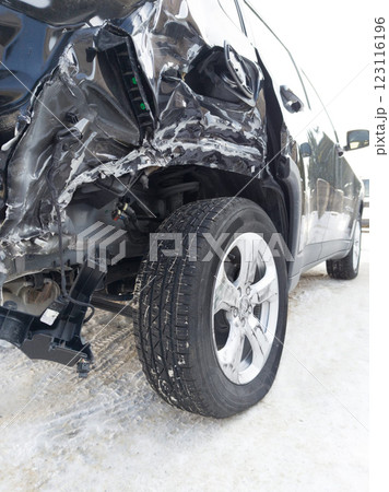 Severely Damaged Car After an Accident on a Snowy Road 123116196