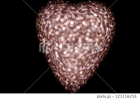 Heart-shaped holiday lights with glowing bokeh effect on dark background Heart-shaped holiday lights with glowing bokeh effect on dark background 123116258