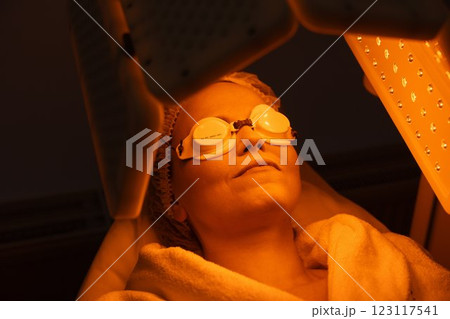 Relaxing skin therapy session under warm light for rejuvenation and care Relaxing skin therapy session under warm light for rejuvenation and care 123117541