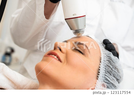 Woman receiving facial treatment in a spa during daytime 123117554