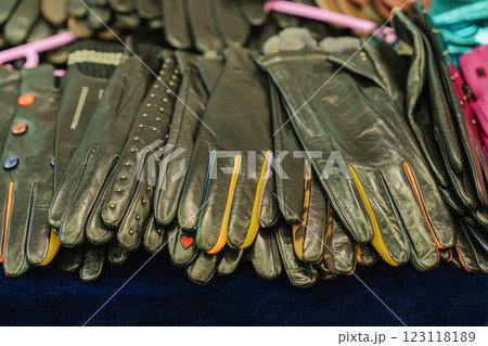 Rows of black leather gloves with colorful detailing on display. Concept of style , winter accessories, craftsmanship Rows of black leather gloves with colorful detailing on display. Concept of style , winter accessories, craftsmanship 123118189