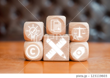 Wooden blocks with icons symbolizing intellectual property, copyright, innovation, and legal protection. 123119603