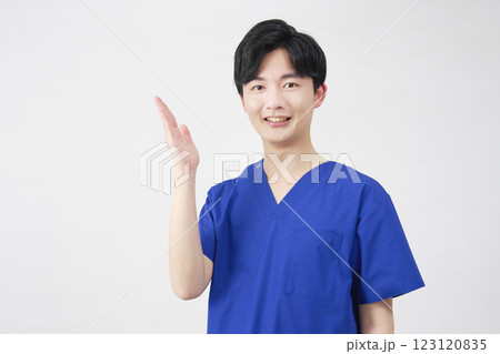 医者・看護師・歯科医師・介護士　左側を手のひらで指す男性　白背景 123120835
