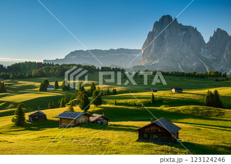 Chalets at Seiser Alm, high altitude meadow with Langkofel mountain in background at sunrise, Dolomites, South Tyrol, Italy Chalets at Seiser Alm, high altitude meadow with Langkofel mountain in background at sunrise, Dolomites, South Tyrol, Italy 123124246